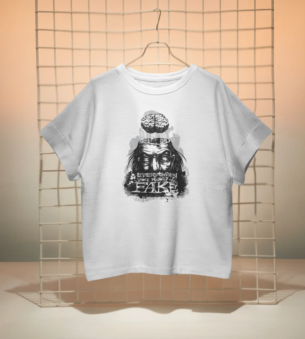 White Short Sleeve T-Shirt, featuring a striking graphic of a face with a brain and the word "FAKE" in a distressed, artistic design